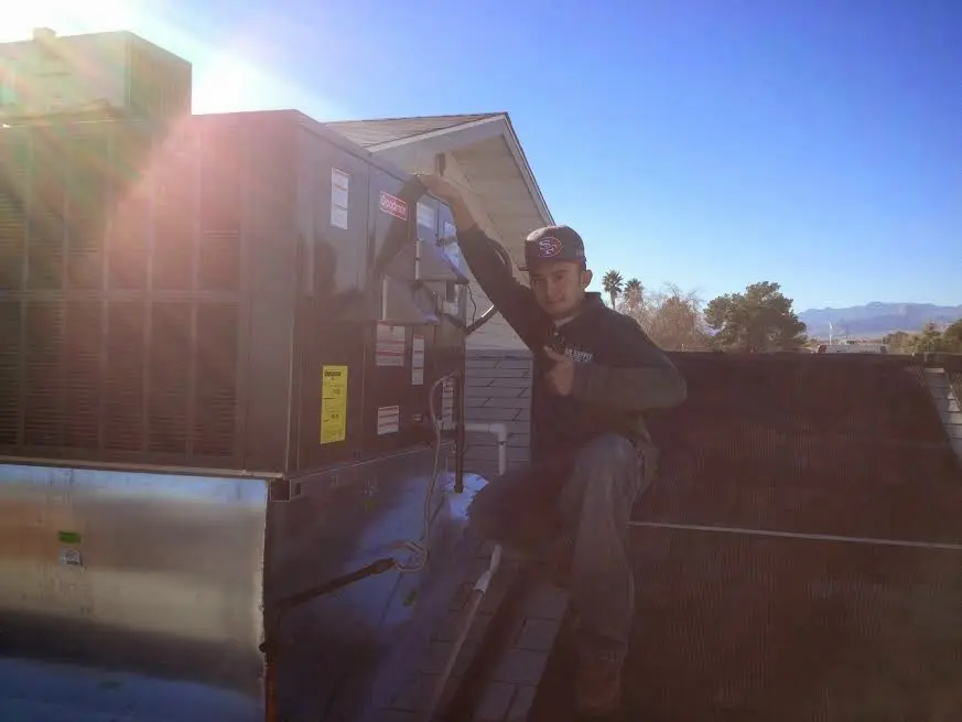 HVAC technician performing HVAC Inspection on a rooftop unit in Dover